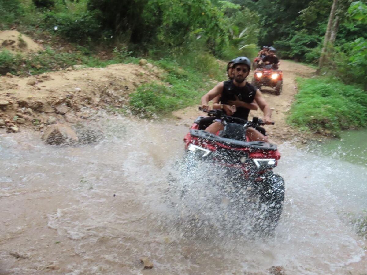 ATV splashing through jungle stream crossing in Koh Samui